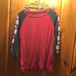 It’s a small red cowgirl-tuff long sleeve with western designs on the sleeve